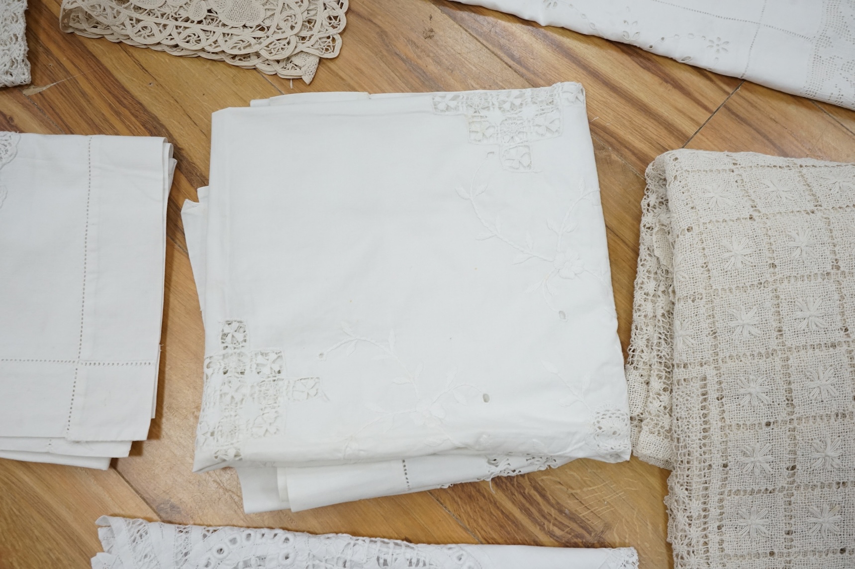 A collection of early 20th century and later crochet, cut work and drawn thread table linens and a large embroidered table cloth